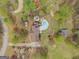 Aerial view of sprawling property with pool, mature landscaping, and circular driveway at 3588 Sw Highridge Dr, Conyers, GA 30094