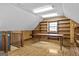 Spacious attic area with built-in shelving, wooden floors, and natural light at 3588 Sw Highridge Dr, Conyers, GA 30094