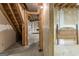 Unfinished basement space with stairs leading to pool table area, ready for customization at 3588 Sw Highridge Dr, Conyers, GA 30094