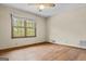 Bright bedroom with hardwood flooring and a large window with views of greenery at 3588 Sw Highridge Dr, Conyers, GA 30094