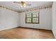 Cozy bedroom with hardwood floors, natural light, and decorative wallpaper at 3588 Sw Highridge Dr, Conyers, GA 30094