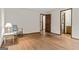 Spacious bedroom with hardwood floors, natural light, and a view to the bathroom at 3588 Sw Highridge Dr, Conyers, GA 30094