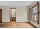A bedroom featuring hardwood floors, natural light, and a door to the bathroom at 3588 Sw Highridge Dr, Conyers, GA 30094