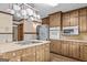 Well-lit kitchen with stainless steel appliances, wood cabinets, and a pot rack at 3588 Sw Highridge Dr, Conyers, GA 30094