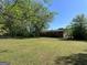 Expansive backyard featuring a well-maintained lawn and mature trees providing shade at 5183 Jones Ct, Morrow, GA 30260