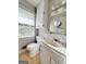 Cozy bathroom featuring a vanity with sink, mirror, toilet, and a window with natural light at 5183 Jones Ct, Morrow, GA 30260