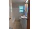 Well-lit bathroom featuring a bathtub and shower, vanity with sink, and a window offering natural light at 5183 Jones Ct, Morrow, GA 30260