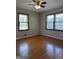 Bright bedroom featuring hardwood floors, a ceiling fan and two large windows providing plenty of natural light at 5183 Jones Ct, Morrow, GA 30260