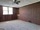 Bedroom with wood paneling, brick wall, ceiling fan and carpet flooring at 5183 Jones Ct, Morrow, GA 30260