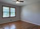 Bright bedroom featuring hardwood floors, a ceiling fan and large window providing plenty of natural light at 5183 Jones Ct, Morrow, GA 30260