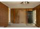 Entryway with wood paneling, brick wall, carpet flooring, and front door at 5183 Jones Ct, Morrow, GA 30260
