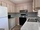 Well-lit kitchen featuring white appliances, updated countertops, and practical layout at 5183 Jones Ct, Morrow, GA 30260