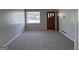 Living room with gray walls, carpet flooring, window, and front door at 5183 Jones Ct, Morrow, GA 30260