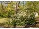Landscaped yard featuring a flowering bush and ornamental wind spinner, adding charm at 5183 Jones Ct, Morrow, GA 30260