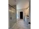 Beautiful bathroom featuring tiled floors, glass shower, separate tub, and dual vanity at 935 S Laney Rd, Locust Grove, GA 30248