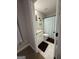 Cozy bathroom features a shower with blue curtain, tile flooring, and a white vanity at 935 S Laney Rd, Locust Grove, GA 30248