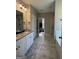 Beautiful bathroom featuring tiled floors, glass shower, separate tub, and dual vanity at 935 S Laney Rd, Locust Grove, GA 30248