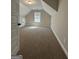 Spacious carpeted bonus room with angled ceilings and a window for natural light at 935 S Laney Rd, Locust Grove, GA 30248