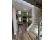Inviting entryway showcasing hardwood floors, a staircase with iron railings, and views into the spacious living room at 935 S Laney Rd, Locust Grove, GA 30248