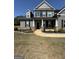 Beautiful two-story home featuring a welcoming front porch with white columns and professionally landscaped front yard at 935 S Laney Rd, Locust Grove, GA 30248