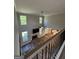 Open-concept living area featuring a brick fireplace, wood floors, and large windows at 935 S Laney Rd, Locust Grove, GA 30248