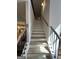 Staircase with hardwood flooring and black iron railings provides access to upper levels at 935 S Laney Rd, Locust Grove, GA 30248
