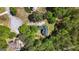 Aerial view of a home nestled among mature trees with a large backyard and a long driveway at 210 Sweetwater Dr, Fayetteville, GA 30214