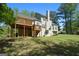 A spacious wooden deck overlooking the manicured backyard of this charming home at 210 Sweetwater Dr, Fayetteville, GA 30214