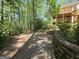 Terraced retaining wall defines the backyard area, which includes a wooded area in the background at 210 Sweetwater Dr, Fayetteville, GA 30214