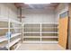 Unfinished basement with concrete block walls and metal shelving, offering ample storage space at 210 Sweetwater Dr, Fayetteville, GA 30214