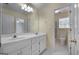 Well-lit bathroom with double sink vanity, large mirror, and a separate shower and toilet area at 210 Sweetwater Dr, Fayetteville, GA 30214