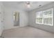 Inviting bedroom with a window, ceiling fan, and ensuite bathroom at 210 Sweetwater Dr, Fayetteville, GA 30214
