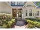 Stunning entryway with a beautiful door, lovely landscaping, and stone accents at 210 Sweetwater Dr, Fayetteville, GA 30214