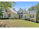 Inviting home with lovely landscaping, stone accents, and a covered front entry at 210 Sweetwater Dr, Fayetteville, GA 30214