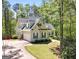 Charming two-story home with attached garage, lush landscaping, and a long driveaway at 210 Sweetwater Dr, Fayetteville, GA 30214