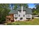 A back exterior featuring a large wooden deck and patio overlooking a lush green lawn at 210 Sweetwater Dr, Fayetteville, GA 30214
