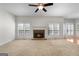 Spacious living room featuring a brick fireplace, carpeted floors, and ample natural light at 210 Sweetwater Dr, Fayetteville, GA 30214