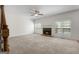 Cozy living room featuring a brick fireplace, carpeted floors, and natural light at 210 Sweetwater Dr, Fayetteville, GA 30214