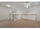 Open loft area featuring plush carpeting, a ceiling fan, and natural light at 210 Sweetwater Dr, Fayetteville, GA 30214