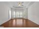 Generous main bedroom boasts wood floors, a tray ceiling, and many bright windows at 210 Sweetwater Dr, Fayetteville, GA 30214