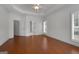 Well-lit primary bedroom features wood floors, ample windows, and a trey ceiling at 210 Sweetwater Dr, Fayetteville, GA 30214