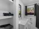 Well-lit bathroom with open shelving, white vanity, quartz counters, and a framed window for natural light at 2903 Monterey Dr, Decatur, GA 30032