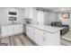 Modern kitchen features white cabinets, granite counters and a stylish sliding barn door at 2903 Monterey Dr, Decatur, GA 30032