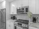 Bright kitchen with stainless steel appliances, modern cabinetry, and granite countertops at 2903 Monterey Dr, Decatur, GA 30032