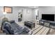 Cozy living room with a comfortable leather couch, a large TV, and modern decor at 2903 Monterey Dr, Decatur, GA 30032