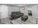 Living room featuring a black leather couch, decorative rug, sliding door, and modern design at 2903 Monterey Dr, Decatur, GA 30032