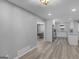 Open concept kitchen, living, and dining area features wood-look floors and neutral paint at 2903 Monterey Dr, Decatur, GA 30032