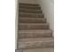 Carpeted stairs leading to the upper level, ensuring safety and comfort for daily use at 6183 Field Stone Dr, Douglasville, GA 30134