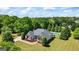 Aerial view of home with a sprawling front lawn and mature trees at 2060 Dixie Rd, Covington, GA 30014