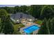 Aerial view of home featuring an inground pool, patio with fire pit, and lush greenery at 2060 Dixie Rd, Covington, GA 30014